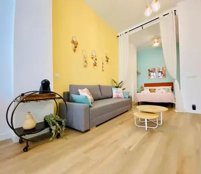 a living room with a couch and a table at Beautiful and Charming Loft in Russafa SOHO in Valencia