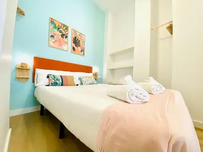 a bedroom with a large bed with towels on it at Beautiful and Charming Loft in Russafa SOHO in Valencia