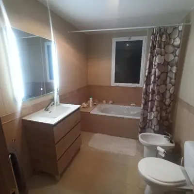a bathroom with a tub and a toilet and a sink at Casa Sol y montaña-habitaciones in Torrent