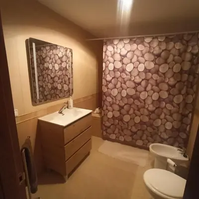 a bathroom with a toilet and a sink and a shower at Casa Sol y montaña-habitaciones in Torrent