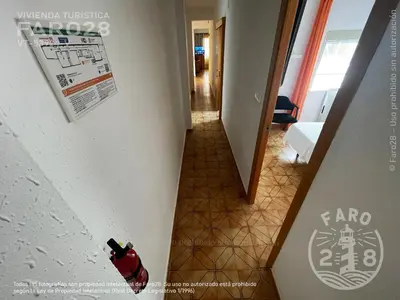a view of a hallway with a bottle of fire extinguisher at Faro28 in Valencia