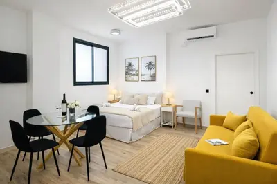 a room with a bed and a table and a couch at Avakian Valencia Centro in Valencia