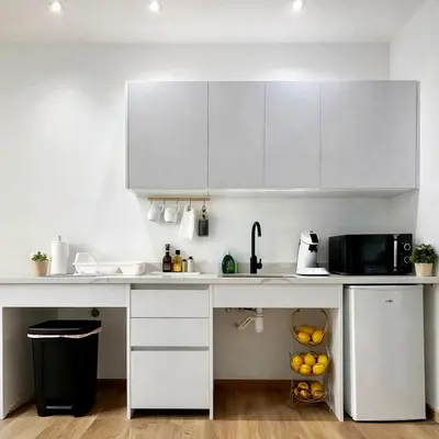 a white kitchen with white cabinets and a microwave at Avakian Valencia Centro in Valencia