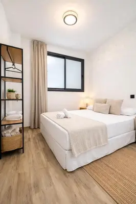a white bedroom with a large bed and a window at Avakian Valencia Centro in Valencia