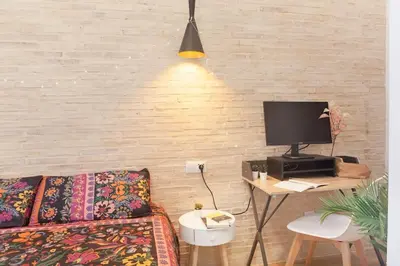 a living room with a couch and a table with a television at RC - Modern Valencia loft in Valencia