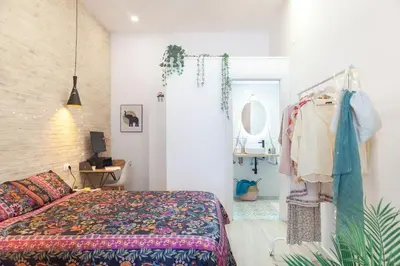 a bedroom with a bed and a table and a mirror at RC - Modern Valencia loft in Valencia