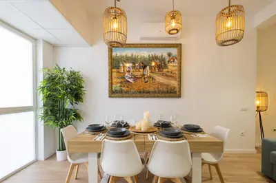 a dining room with a table with chairs and a painting on the wall at 2 rooms 4 Pax, new flat, wifi AC in Valencia