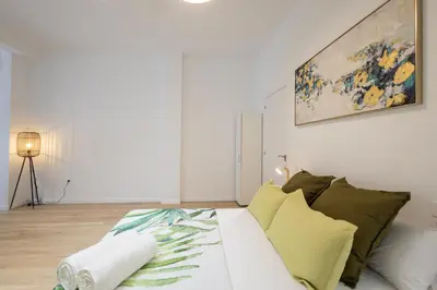 a living room with a couch and a painting on the wall at 2 rooms 4 Pax, new flat, wifi AC in Valencia