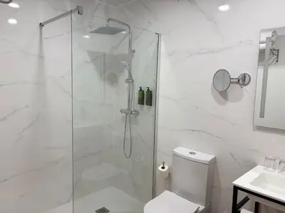 a bathroom with a shower with a toilet and a sink at SH Campus Lyceum in Moncada