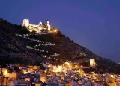 a city lit up at night with a castle on a hill at Cerca del mar, ascensor, descuentos semanales 4 personas in Cullera
