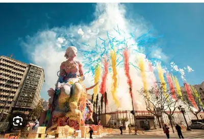 a building with a colorful fountain in a city at Cerca del mar, ascensor, descuentos semanales 4 personas in Cullera