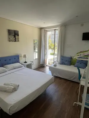 a bedroom with two beds and a window at El Parterre Apartamento in Valencia