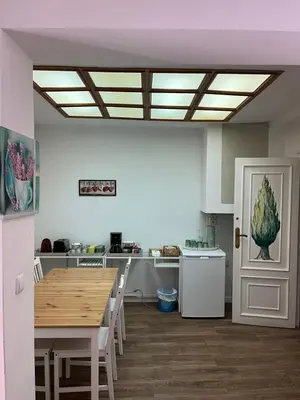 a kitchen with a wooden table and a dining room at El Parterre Apartamento in Valencia