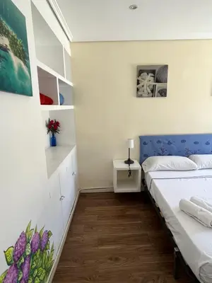 a bedroom with a bed with a blue headboard at El Parterre Apartamento in Valencia
