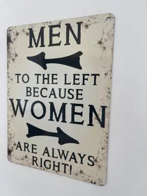 a sign that says men to the left because women are always right at Garage House in Calles