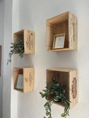 a bunch of wooden boxes on a wall with a plant at Garage House in Calles