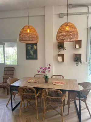 a dining room with a wooden table and chairs at Garage House in Calles