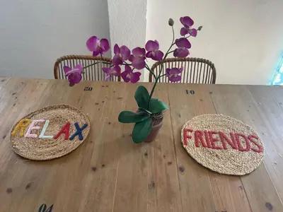 a wooden table with two chairs and a plant on it at Garage House in Calles