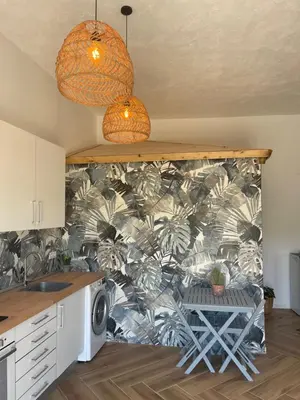 a kitchen with a wallpaper with palm trees on it at Garage House in Calles