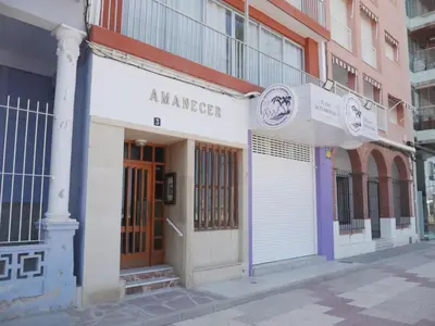 a building on a city street with a garage at Amanecer, 1-2 in Cullera