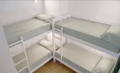 a white refrigerator with empty shelves in a room at Aiora Hostel in Valencia