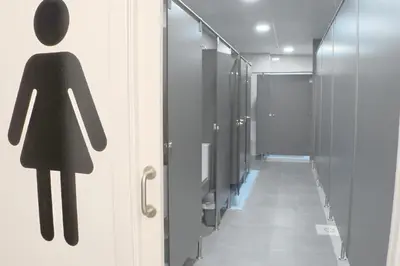 a sign of a woman on a door in a bathroom at Aiora Hostel in Valencia