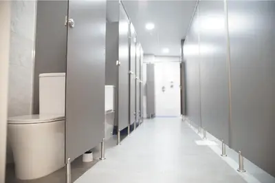 a row of stalls in a bathroom with a toilet at Aiora Hostel in Valencia