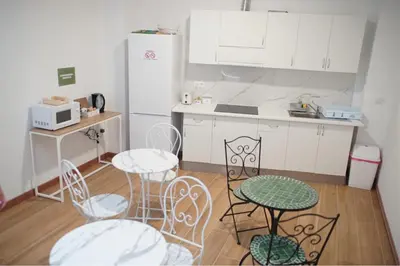 a kitchen with a table and chairs and a refrigerator at Aiora Hostel in Valencia