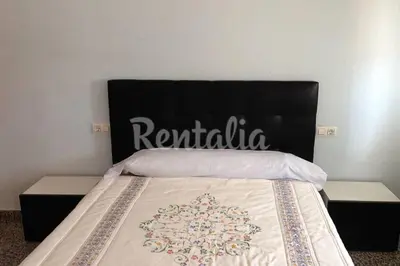 a bedroom with a bed with a sign on it at Apartamento para 5 personas en Faro de Cullera in Faro de Cullera