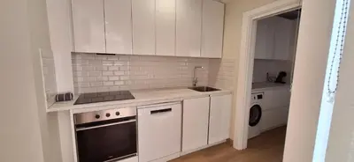a white kitchen with a sink and a stove at El Mercado in Puerto de Sagunto
