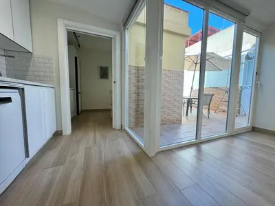an empty kitchen with a sliding glass door to a patio at El Mercado in Puerto de Sagunto