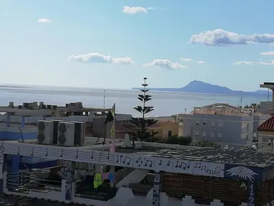 a view of a city with the ocean in the background at Jardin II Solo Familias Serviplaya in Playa de Xeraco