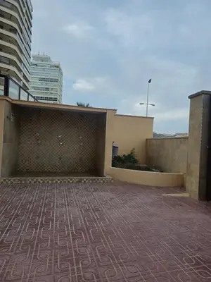 a building with a wall and a brick patio at Beach view apartment in Cullera in Cullera