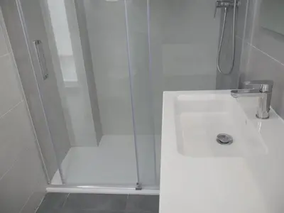 a white bathroom with a shower with a sink at Bellaterra, BQ-2, BAJO A in Cullera
