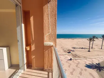 a balcony with a view of the beach at Apartamento primera línea playa San Antonio in Cullera