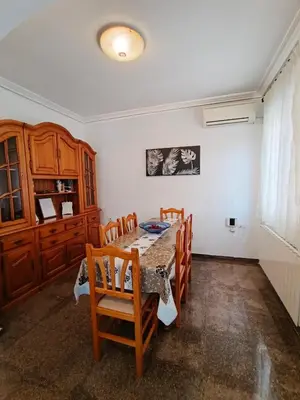a dining room with a table and chairs and a window at Entre Mar y Montañas in Vall de Uixó
