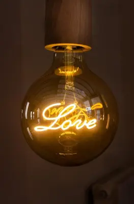 a light hanging from a ceiling with a light bulb at Mediterranean Boutique Fisherman's House in Valencia