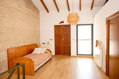 a bedroom with a bed and a brick wall at Mediterranean Boutique Fisherman's House in Valencia