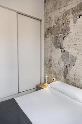 a bedroom with a bed and a large window at Mercado Central Suites in Valencia