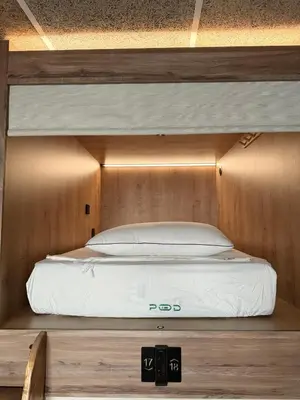 a bunk bed in a room with a wooden wall at The POD Suite Hostel Village in Valencia