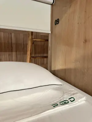 a close up of a bed in a room at The POD Suite Hostel Village in Valencia