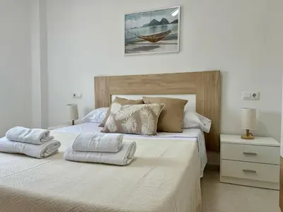a bedroom with a large bed with towels on it at Vistas al Castell de Alacuas in Alaquas