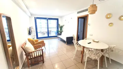 a living room with a white table and chairs at BEACH VALENCIA LUXURY D15-9 Apartment with terrace and sea views with two rooms in Valencia