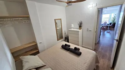 a bedroom with a bed and a dresser and a mirror at Vista Mar Apartamento Playa Farnals in Playa Pobla de Farnals