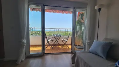 a bedroom with a sliding glass door to a balcony at Vista Mar Apartamento Playa Farnals in Playa Pobla de Farnals