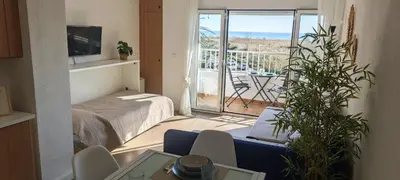 a room with a bed and a view of a balcony at Vista Mar Apartamento Playa Farnals in Playa Pobla de Farnals
