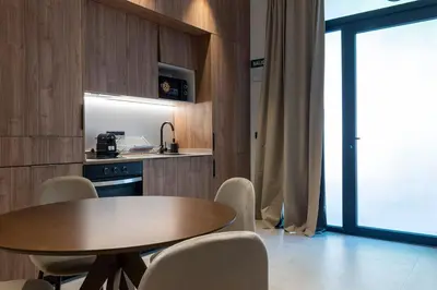 a kitchen with a wooden table and chairs and a table and a table at VLC HOST - Zapadores in Valencia
