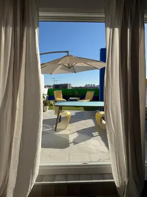 a view of a patio with a table and an umbrella at Petite Penthouse with the sunniest terrace in Valencia in Valencia