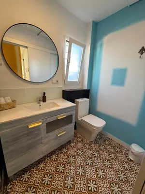 a bathroom with a sink and a mirror and a toilet at Petite Penthouse with the sunniest terrace in Valencia in Valencia