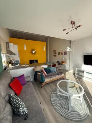 a living room with a couch and a table at Petite Penthouse with the sunniest terrace in Valencia in Valencia